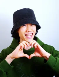 Youseop making a heart with his hands